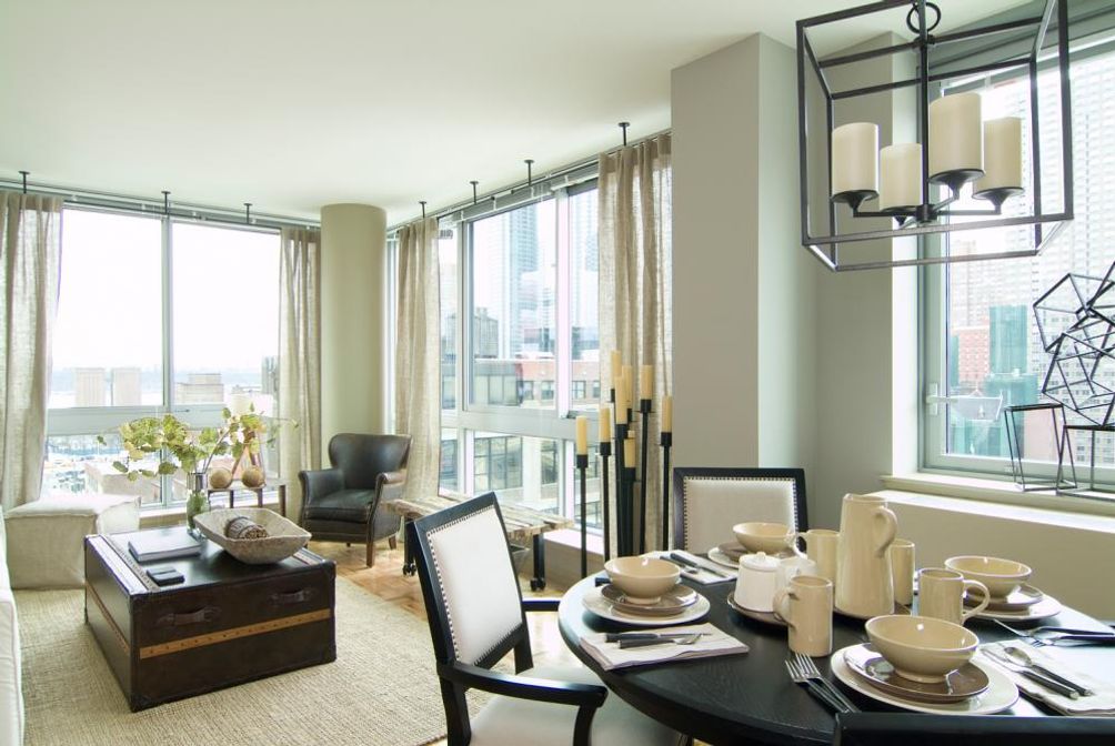 Living area with floor-to-ceiling windows via TF Cornerstone