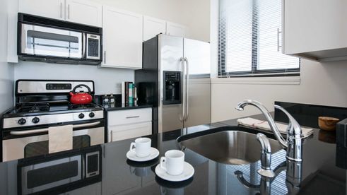 Model unit at 180 Montague Street with contemporary kitchen and appliances