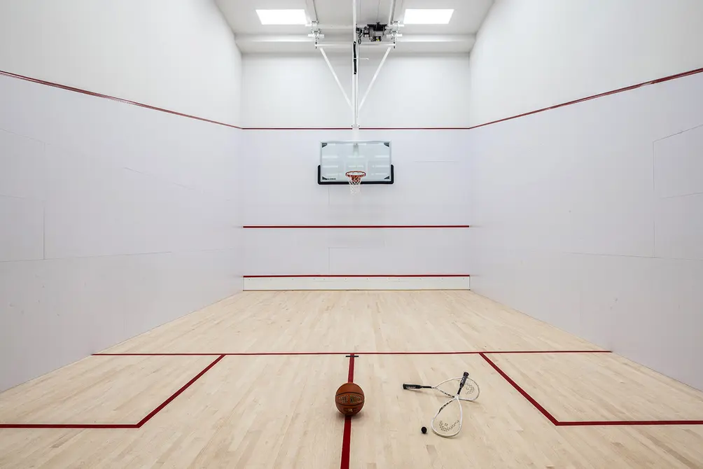 Squash court with basketball hoop