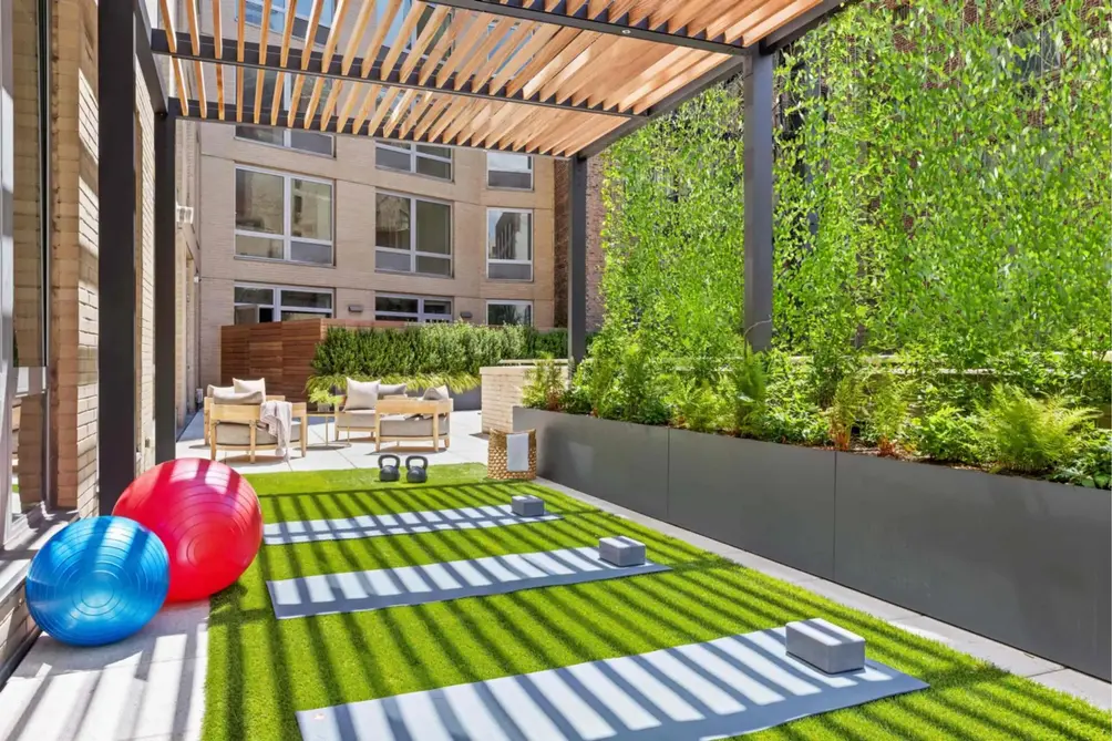 Outdoor terrace with yoga mats and landscaping