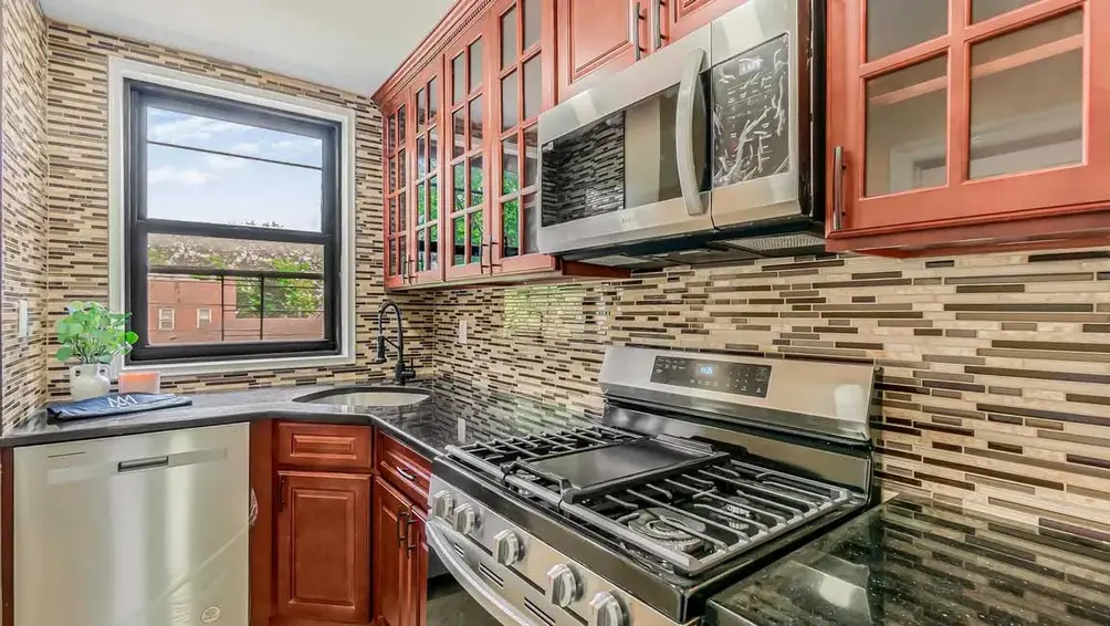 Windowed kitchen with stainless steel appliances