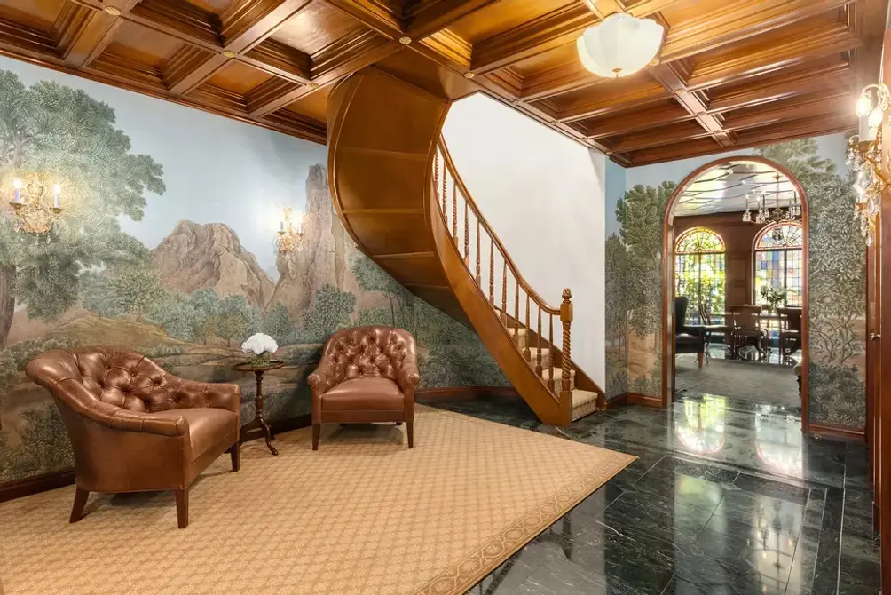 Foyer with mural wall and curved staircase