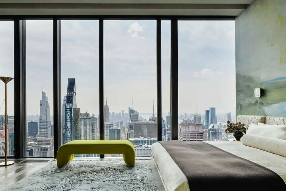Primary bedroom with floor-to-ceiling views of the Midtown skyline