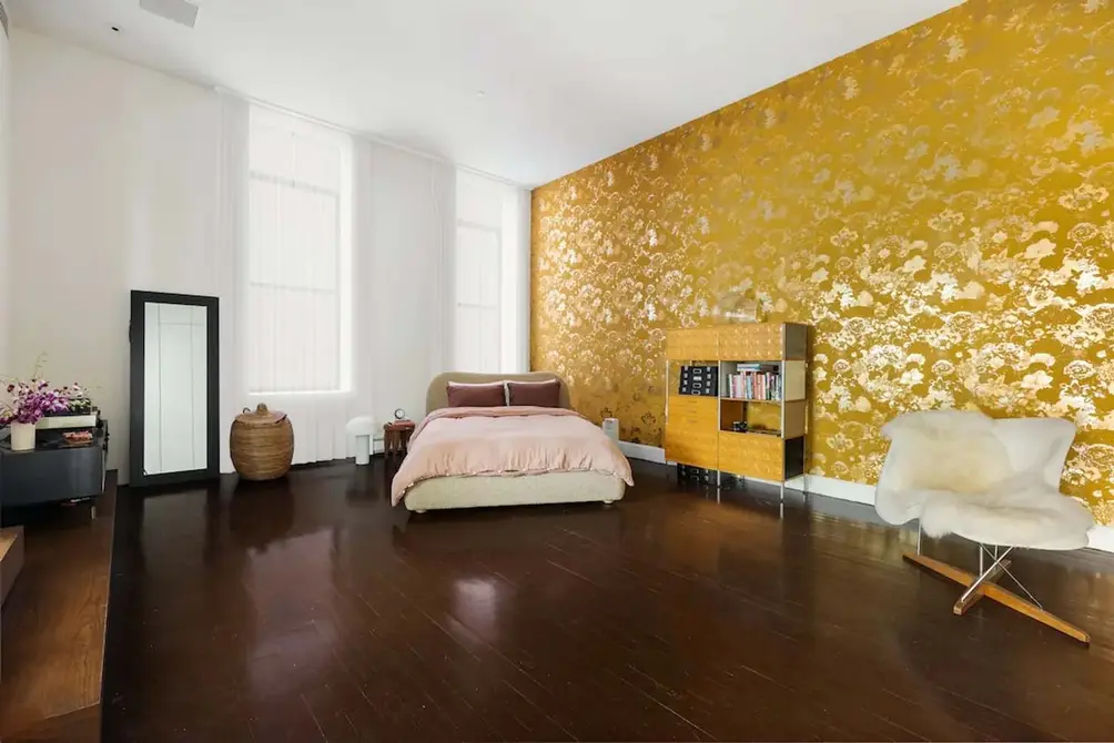 Bedroom with gold-patterned accent wall