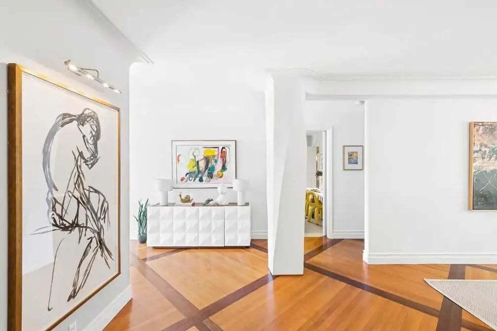 Foyer with hardwood floors and gallery walls