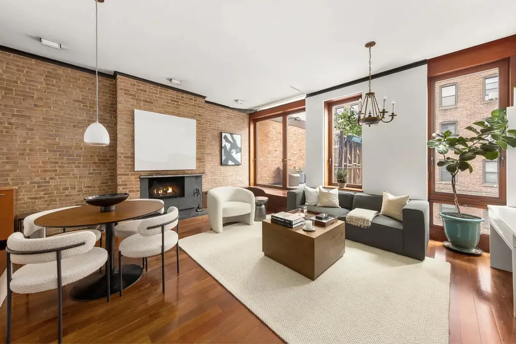 Living room with brick wall and fireplace