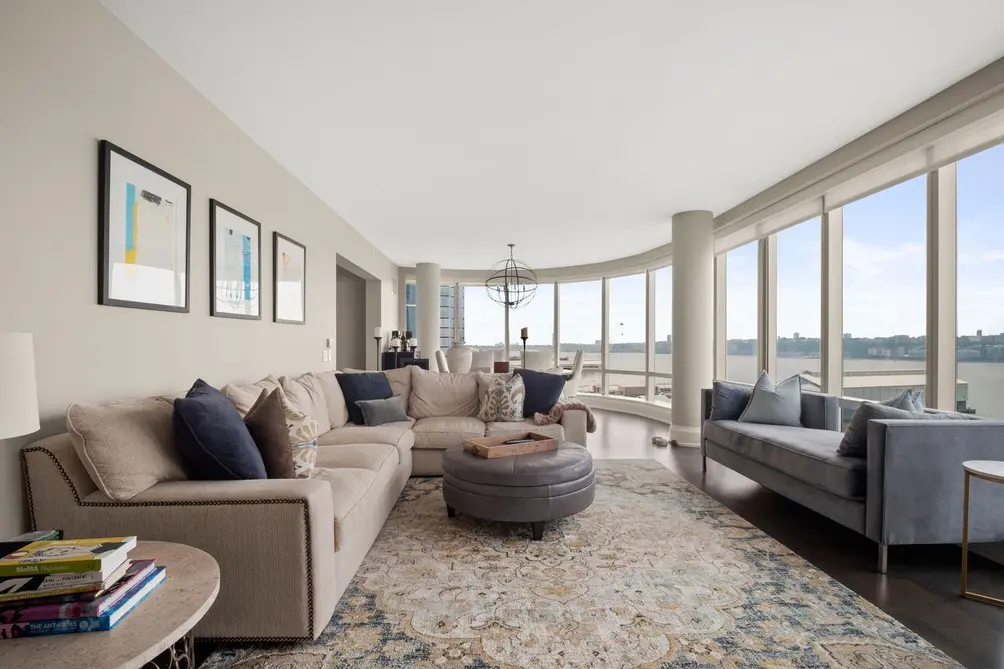 Living room with wall of windows facing the Hudson River