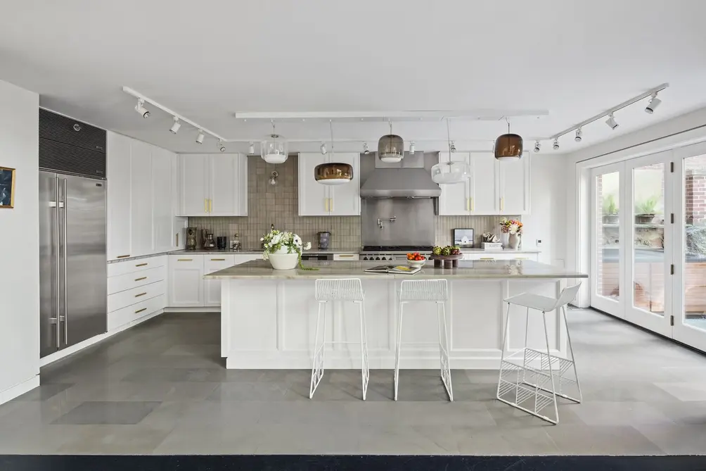 Windowed kitchen with center island and stainless steel appliances