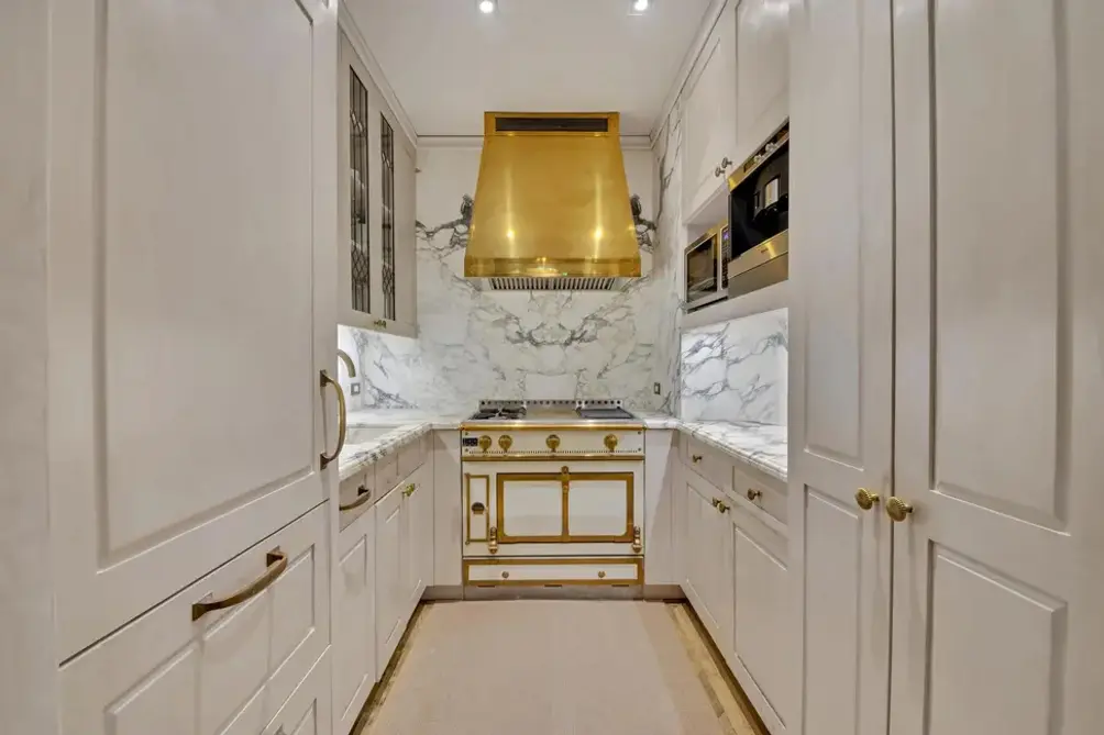 Separate kitchen with gold accents