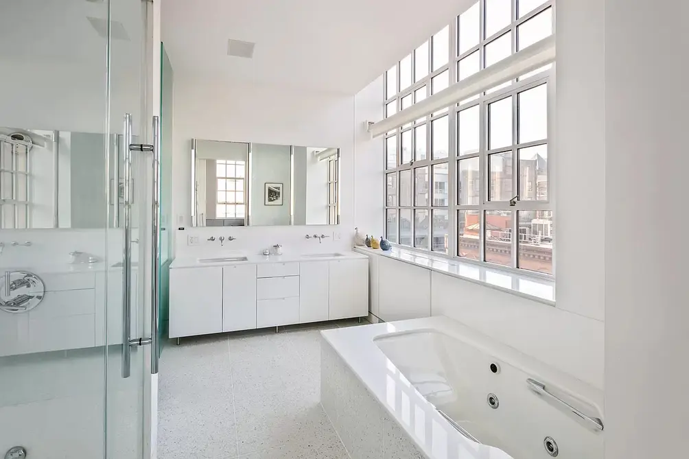 Primary bath with glass-walled shower and soaking tub