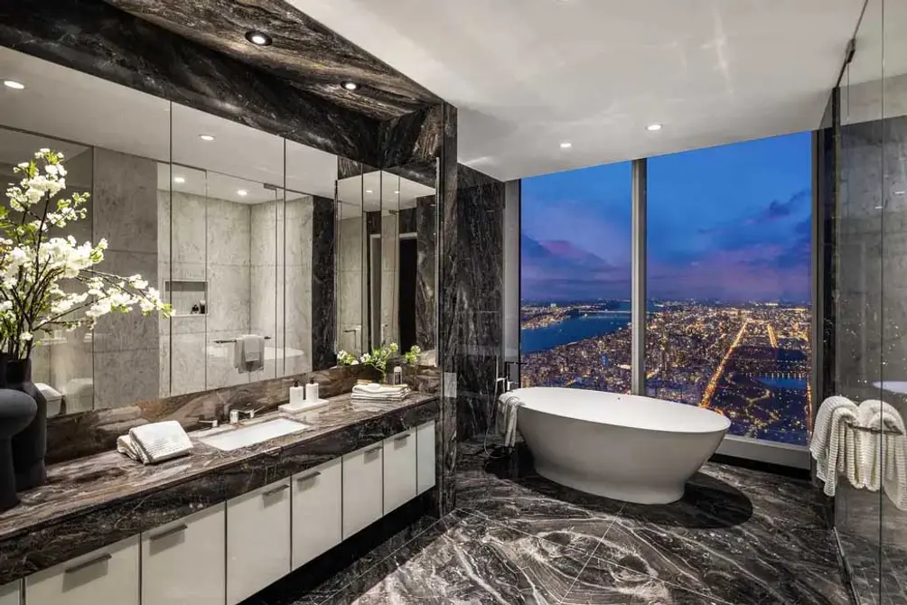 Primary bath with separate tub and floor-to-ceiling windows