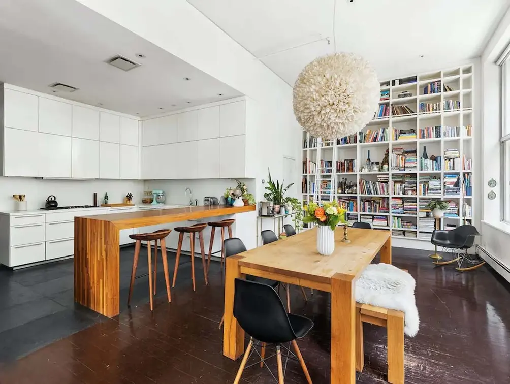 Open kitchen with dining area and built-in shelving