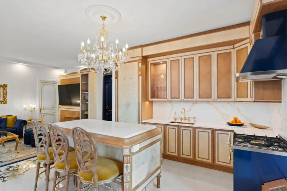Kitchen with custom cabinetry and chandelier