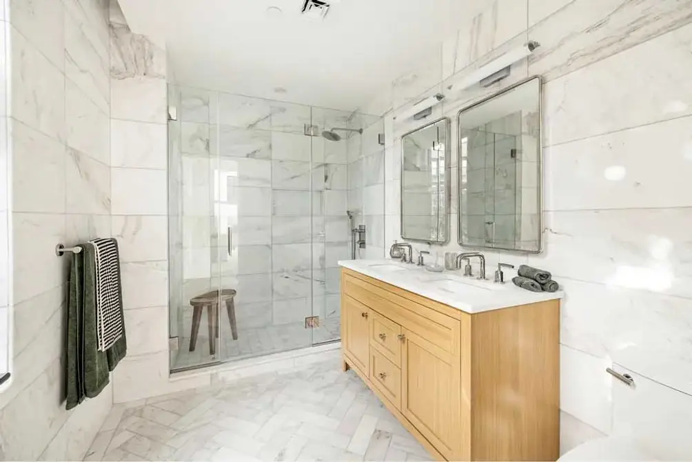 Primary bath with herringbone floors and walk-in shower
