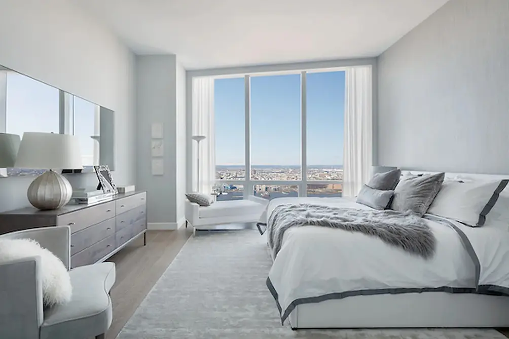 King-sized primary bedroom with city views