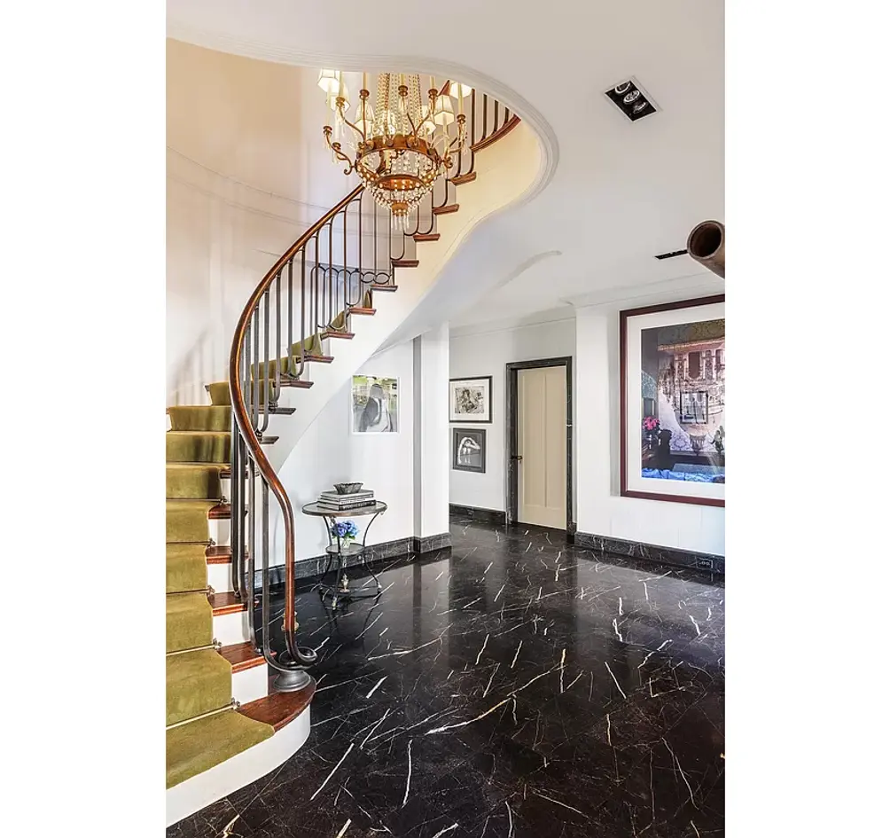 Foyer with curved staircase connecting both levels