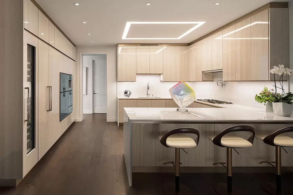 Kitchen with integrated appliances and breakfast bar