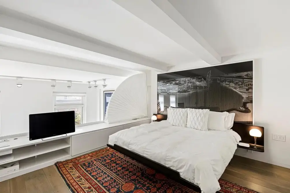 Upper-level bedroom with beamed ceiling