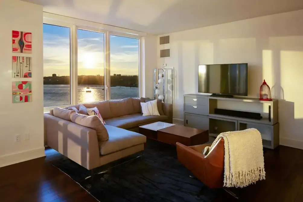 Living room with Hudson River and sunset views