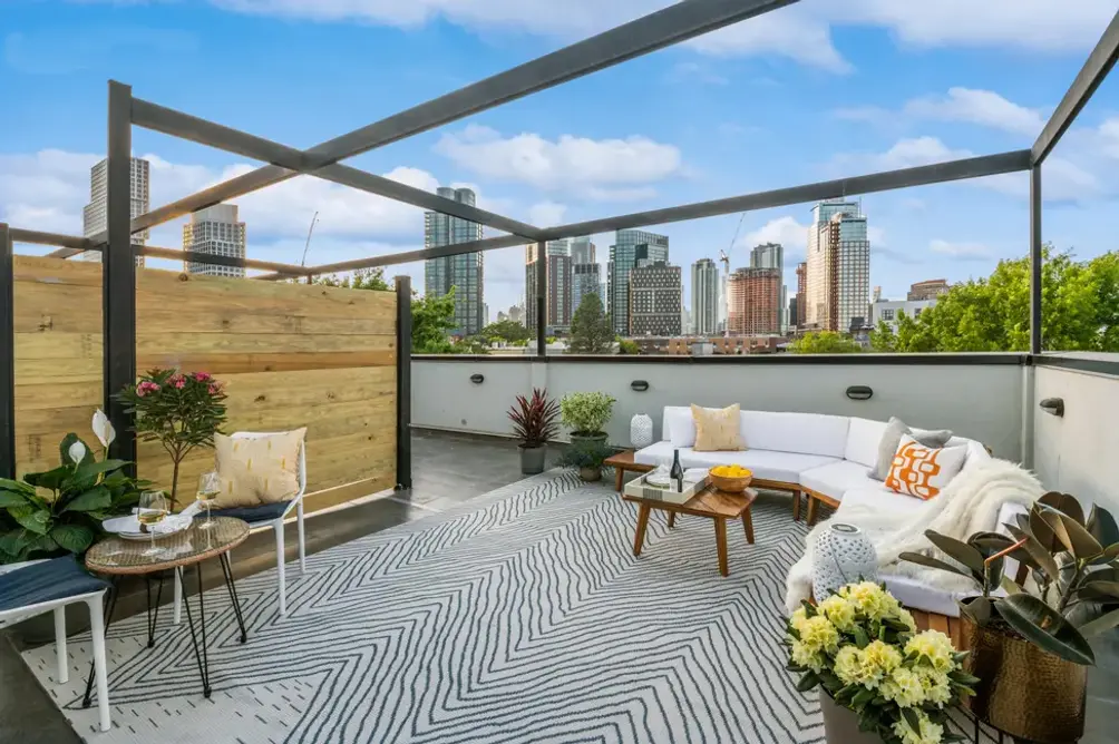Roof deck with seating area and city views