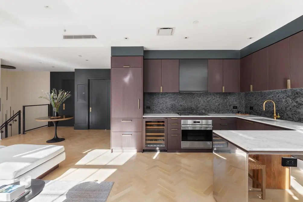 Open kitchen with high-end appliances, including wine fridge