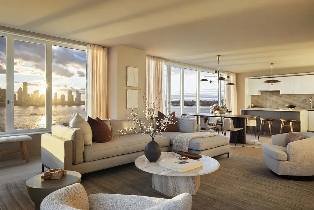 Living room with Hudson River views at golden hour