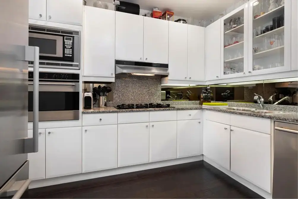 Kitchen with white lacquer cabinetry and stainless steel appliances