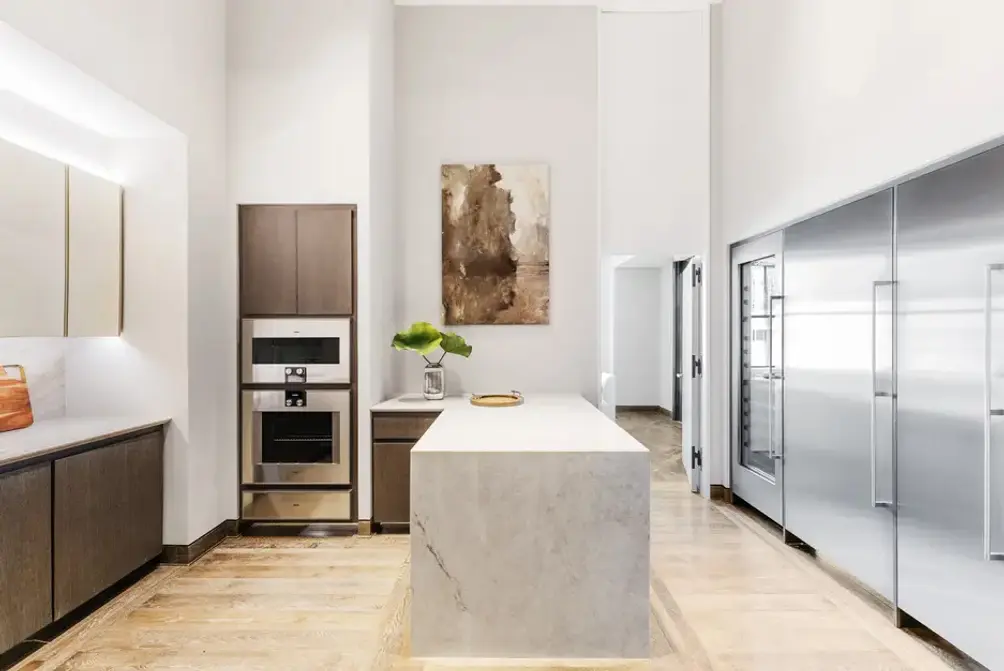 Separate kitchen with center island and high-end appliances