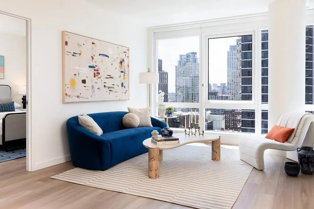 Living room and glimpse of bedroom with city views