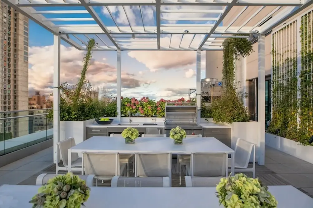 Rooftop terrace with outdoor kitchen and dining area