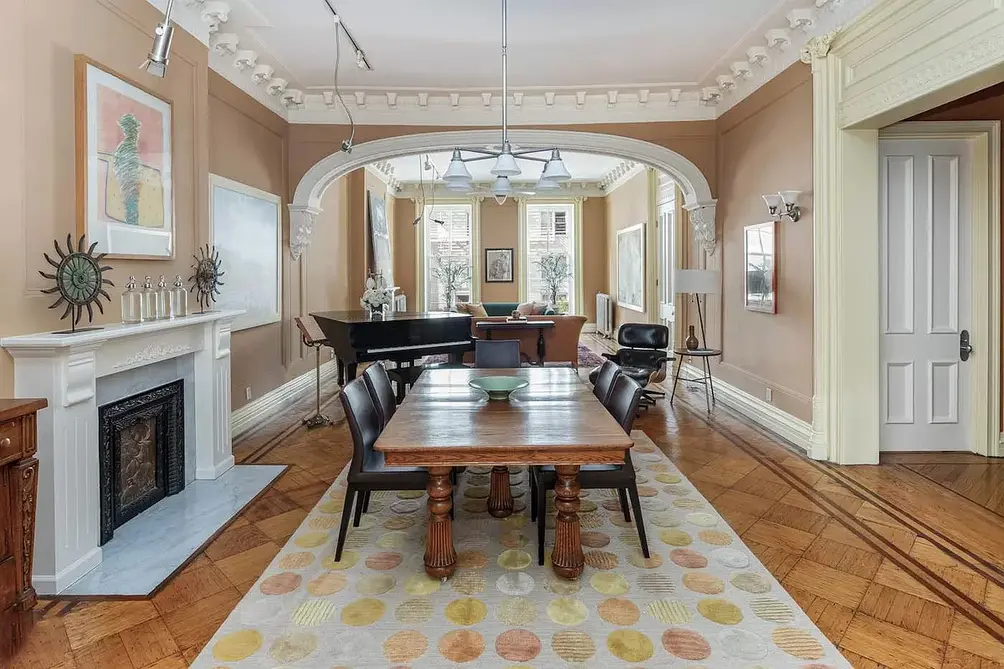 Interiors with arched entry and dining room with fireplace