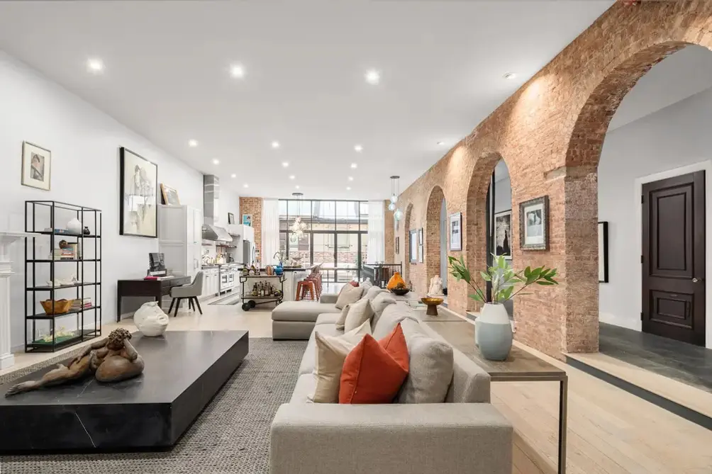 Living room with exposed brick and arched entry