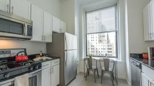 Eat-in kitchen with stainless steel appliances at 71 Broadway