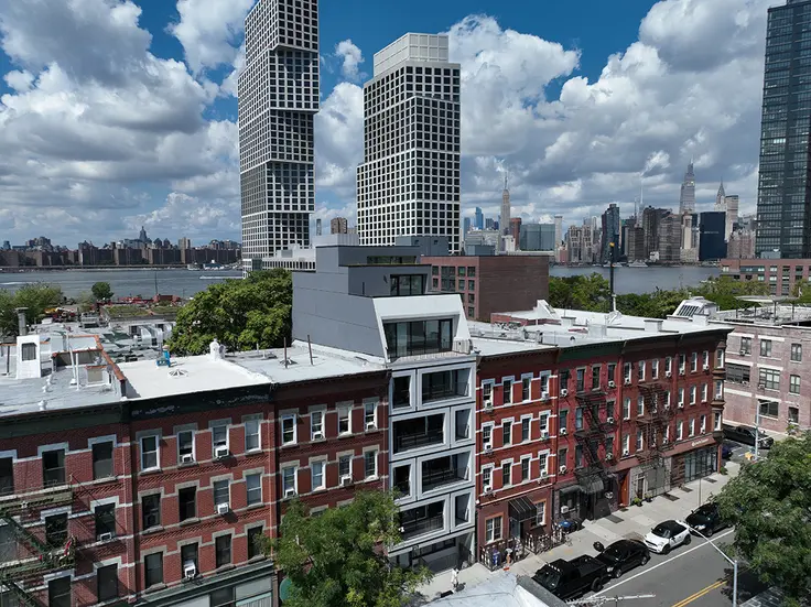 Amidst the historic buildings of Greenpoint, a residential building boom has taken shape. (217 Franklin Street with Eagle + West in the background - Compass)