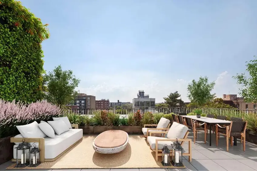 The more amenities an apartment building has, the higher monthly fees will inevitably be. (Brooklyn Bloom common roof terrace - Douglas Elliman)