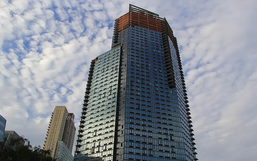 The Hayden stands at 43-25 Hunter Street in LIC, featuring a distinctive glass facade.